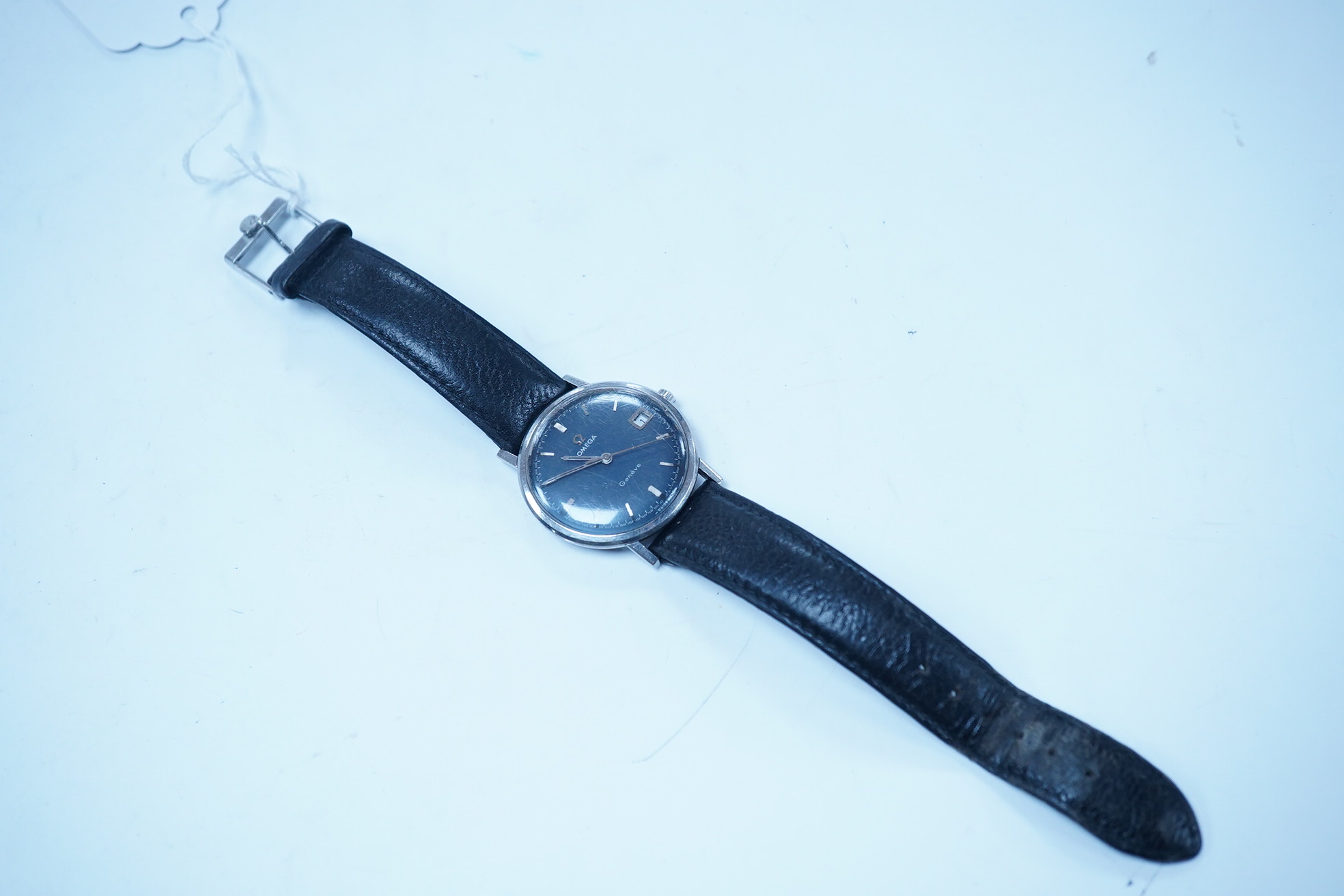 A gentleman's late 1960's stainless steel Omega manual wind wrist watch, with baton numerals and date aperture, movement c.613, case diameter 34mm, on a later associated leather strap. Condition - poor to fair